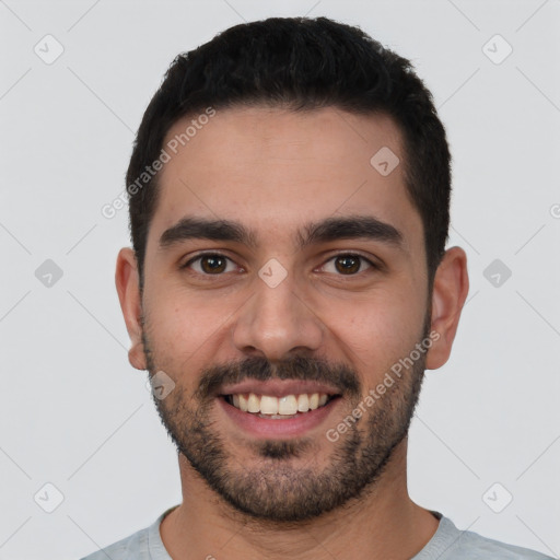 Joyful white young-adult male with short  black hair and brown eyes