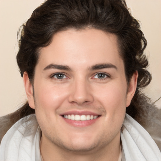 Joyful white young-adult male with medium  brown hair and brown eyes