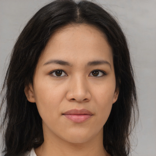 Joyful asian young-adult female with long  brown hair and brown eyes