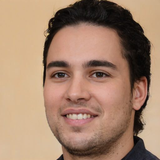 Joyful white young-adult male with short  black hair and brown eyes