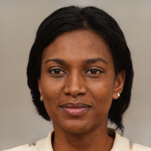 Joyful black adult female with short  black hair and brown eyes