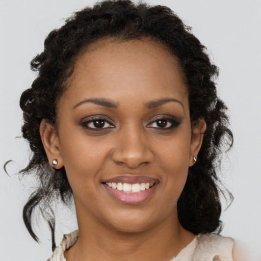 Joyful black young-adult female with long  brown hair and brown eyes