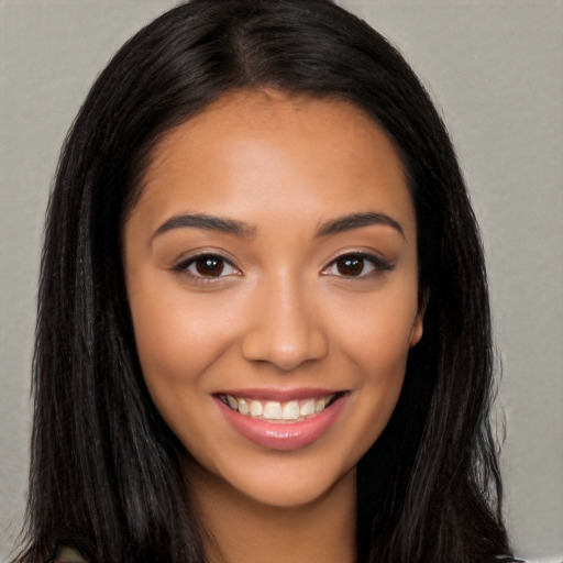 Joyful latino young-adult female with long  brown hair and brown eyes