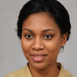 Joyful black young-adult female with medium  brown hair and brown eyes