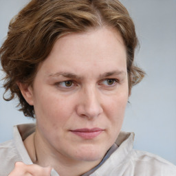 Joyful white adult female with medium  brown hair and blue eyes