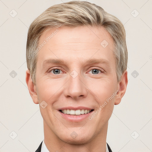 Joyful white adult male with short  brown hair and grey eyes