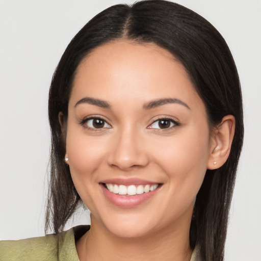 Joyful latino young-adult female with long  brown hair and brown eyes