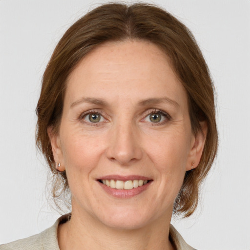 Joyful white adult female with medium  brown hair and grey eyes