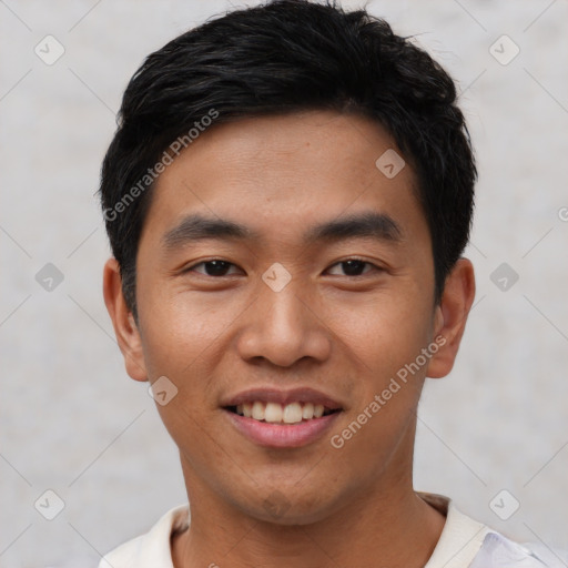 Joyful asian young-adult male with short  black hair and brown eyes