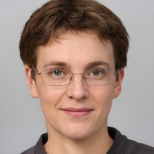 Joyful white adult male with short  brown hair and grey eyes