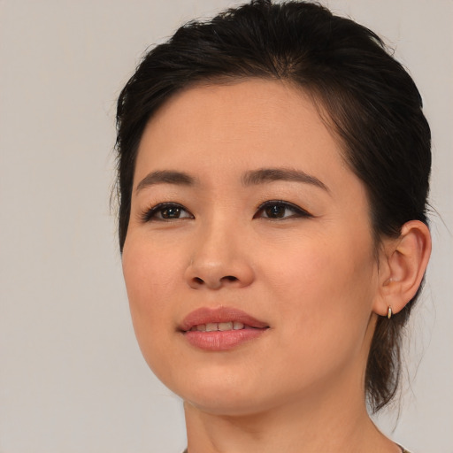 Joyful asian young-adult female with medium  brown hair and brown eyes