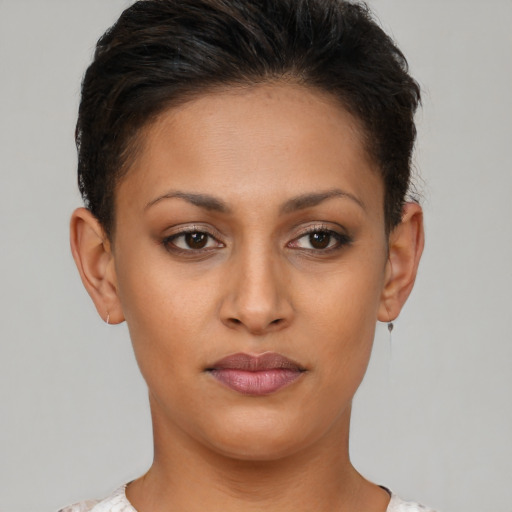 Joyful latino young-adult female with short  brown hair and brown eyes