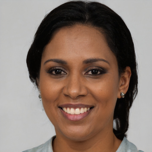 Joyful latino young-adult female with medium  black hair and brown eyes