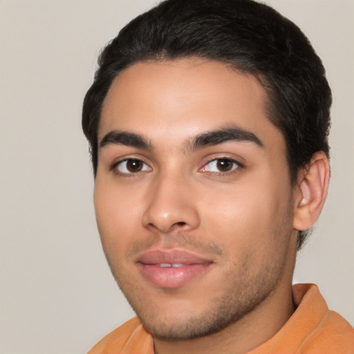 Joyful latino young-adult male with short  black hair and brown eyes