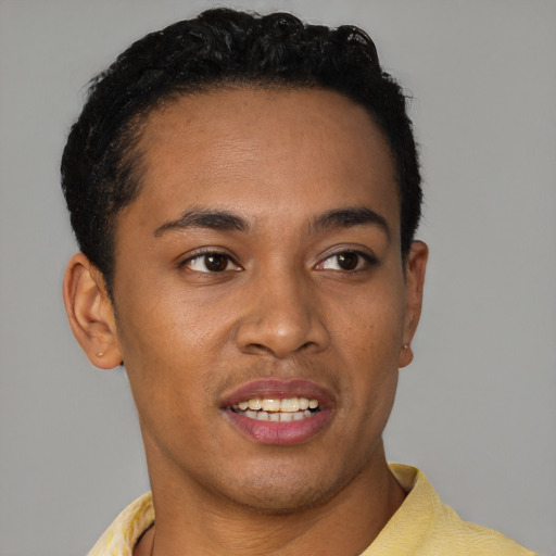 Joyful black young-adult male with short  brown hair and brown eyes