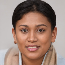 Joyful latino young-adult female with short  brown hair and brown eyes