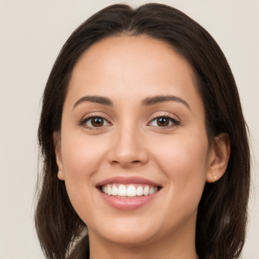 Joyful white young-adult female with long  brown hair and brown eyes