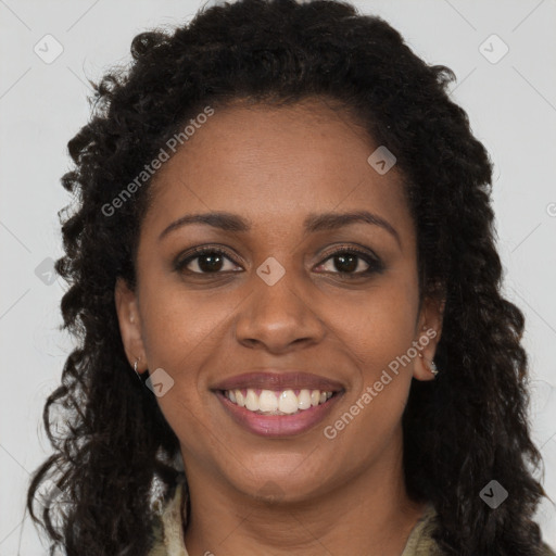 Joyful black young-adult female with long  brown hair and brown eyes