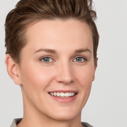 Joyful white young-adult female with short  brown hair and grey eyes