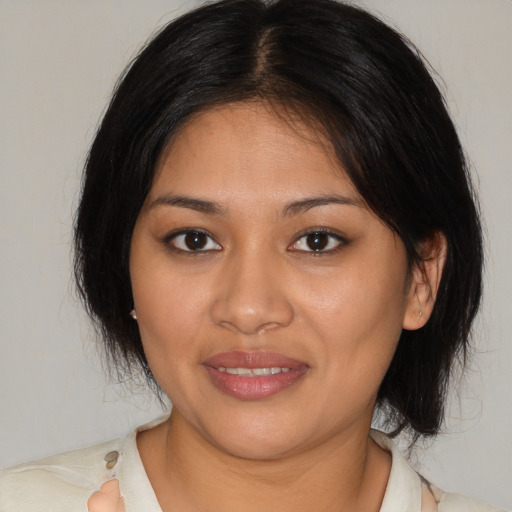 Joyful latino young-adult female with medium  brown hair and brown eyes