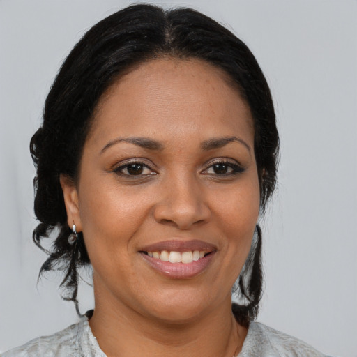 Joyful black young-adult female with medium  brown hair and brown eyes