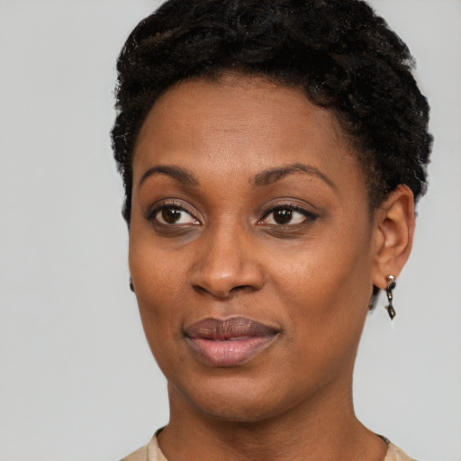 Joyful black young-adult female with short  black hair and brown eyes