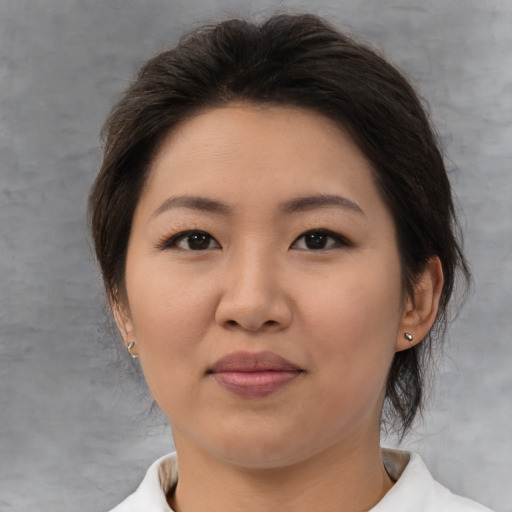 Joyful asian young-adult female with medium  brown hair and brown eyes