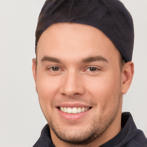 Joyful white young-adult male with short  brown hair and brown eyes