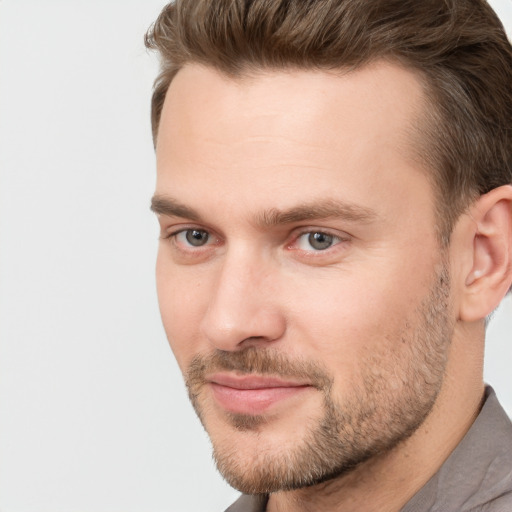 Joyful white young-adult male with short  brown hair and brown eyes