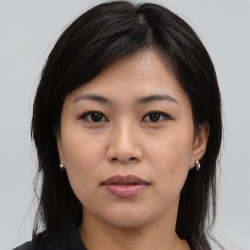 Joyful asian young-adult female with medium  brown hair and brown eyes