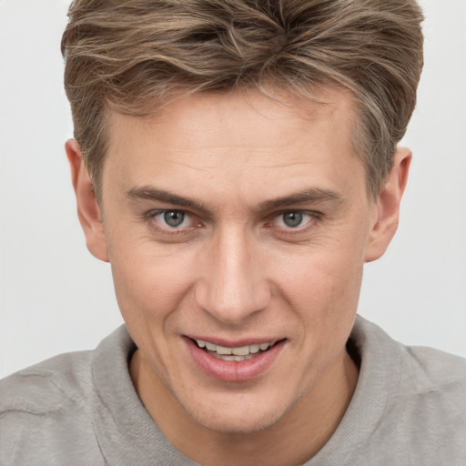 Joyful white adult male with short  brown hair and brown eyes