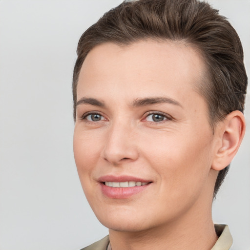 Joyful white young-adult female with short  brown hair and brown eyes