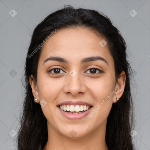 Joyful latino young-adult female with long  brown hair and brown eyes