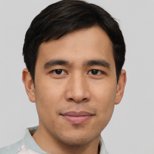 Joyful asian young-adult male with short  brown hair and brown eyes