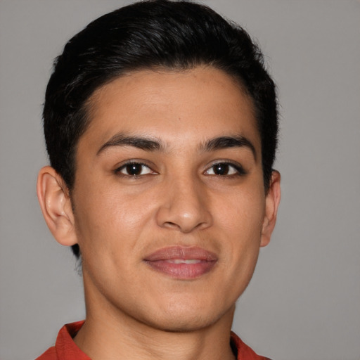 Joyful latino young-adult male with short  brown hair and brown eyes