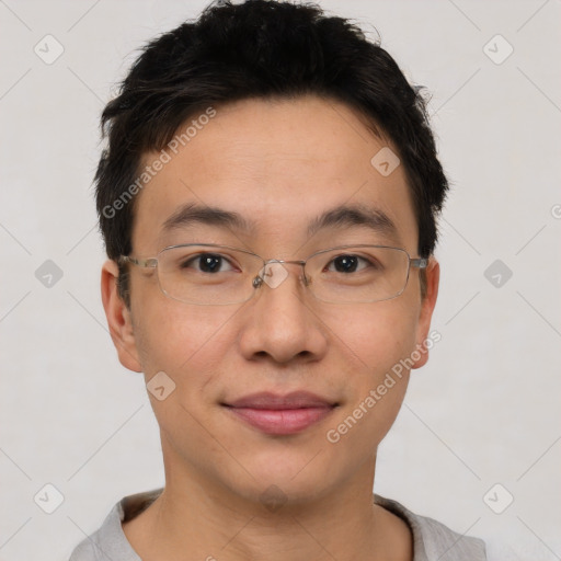 Joyful asian young-adult male with short  brown hair and brown eyes