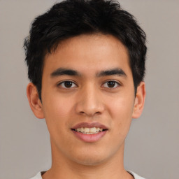 Joyful asian young-adult male with short  brown hair and brown eyes