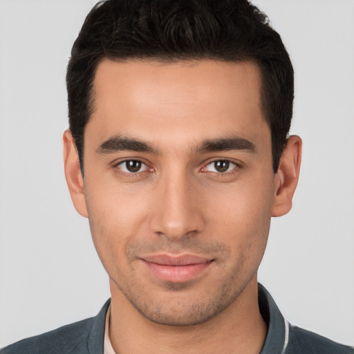 Joyful white young-adult male with short  black hair and brown eyes