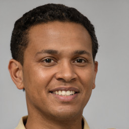 Joyful latino young-adult male with short  brown hair and brown eyes