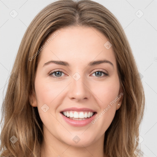 Joyful white young-adult female with long  brown hair and green eyes