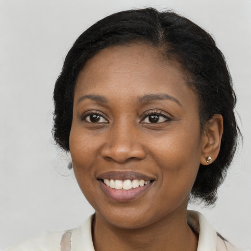 Joyful black young-adult female with medium  black hair and brown eyes