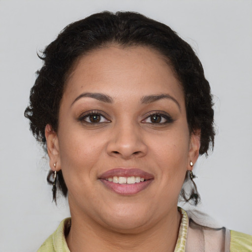 Joyful latino young-adult female with medium  brown hair and brown eyes