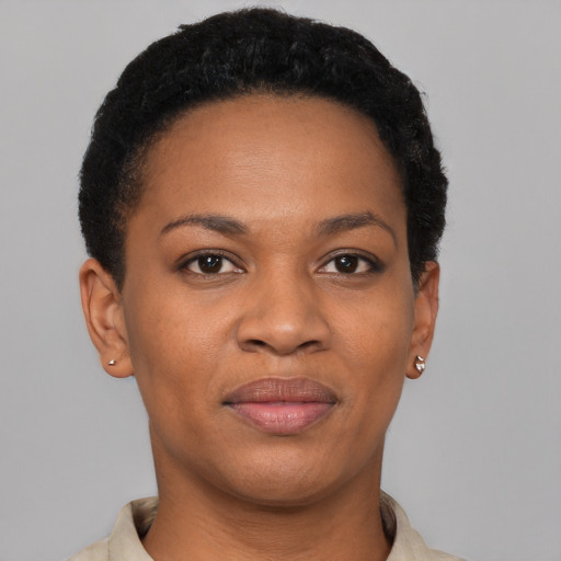 Joyful black young-adult female with short  brown hair and brown eyes