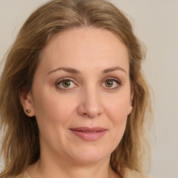 Joyful white young-adult female with medium  brown hair and green eyes