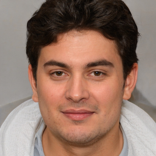 Joyful white young-adult male with short  brown hair and brown eyes