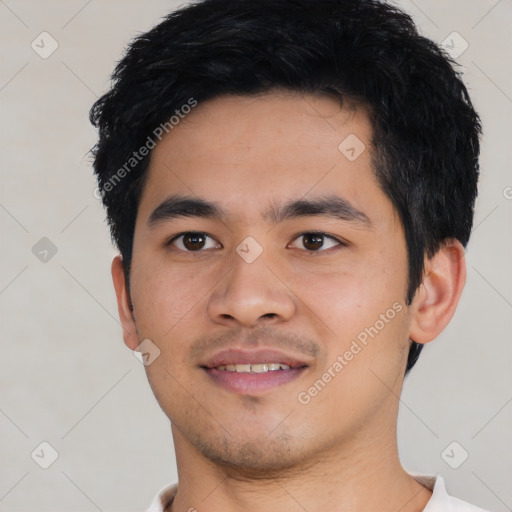 Joyful asian young-adult male with short  black hair and brown eyes