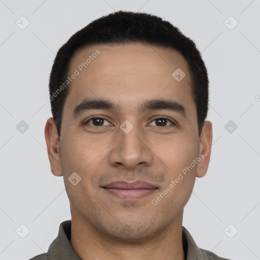 Joyful latino young-adult male with short  black hair and brown eyes