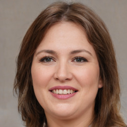 Joyful white adult female with medium  brown hair and brown eyes