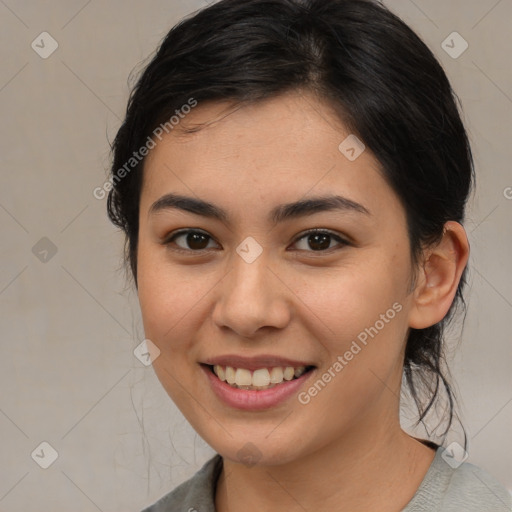 Joyful latino young-adult female with medium  brown hair and brown eyes