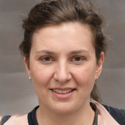 Joyful white adult female with medium  brown hair and grey eyes